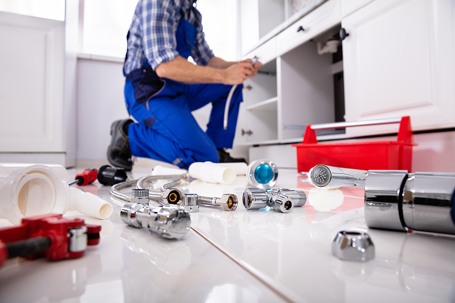 Plumber cleaning up after homeowner tried to fix it themselves